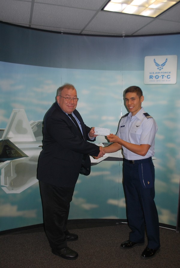 Francis Mazzocchi (l), chapter vice president, presents Air Force Cadet Niall P. Brown with a $3,000 scholarship in August recognizing his accomplishments both in academics and community service. 